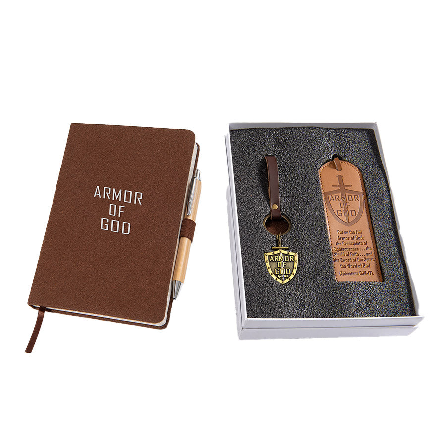 Brown notebook with 'Armor of God' text, pen, and keychain set in a box on a white background