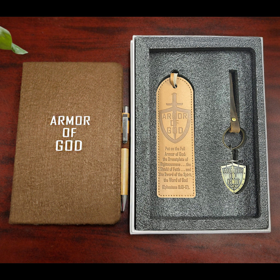 Notebook and keychain set with 'Armor of God' design on a wooden surface