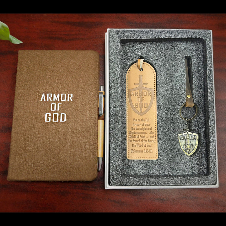 Notebook and keychain set with 'Armor of God' design on a wooden surface