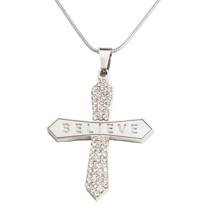 Silver cross pendant with 'BELIEVE' engraving on a white background