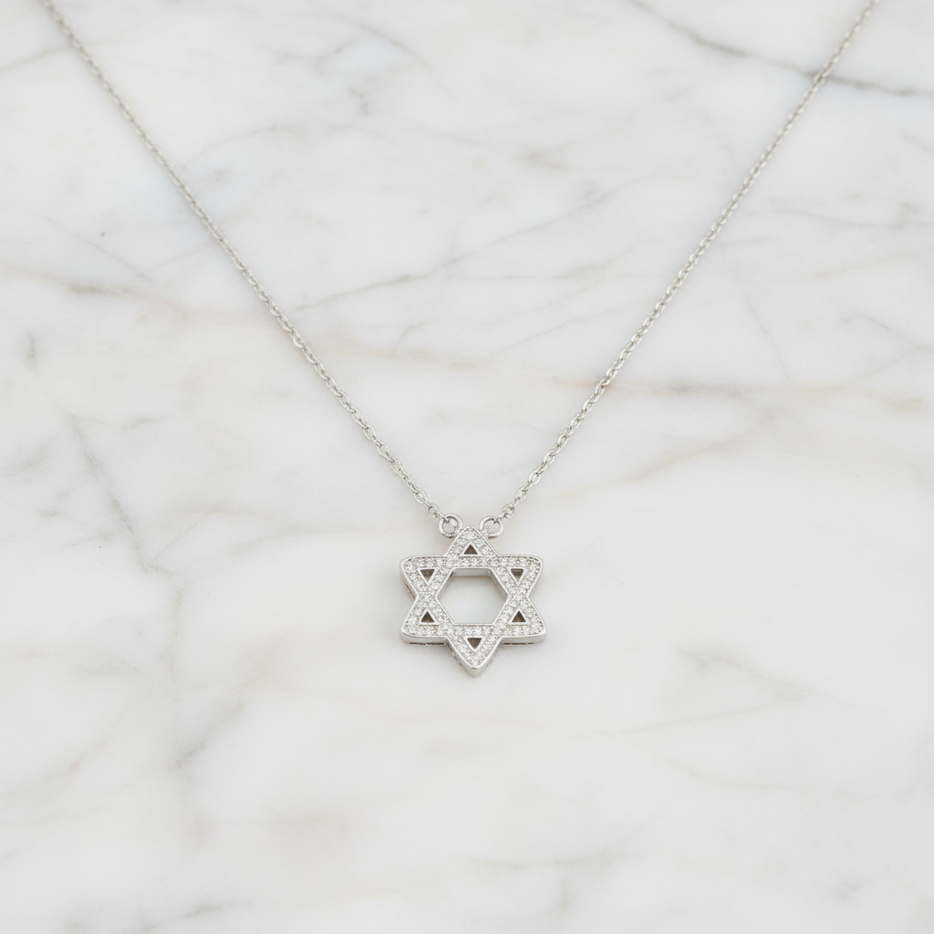 Star of David Necklace on marble background