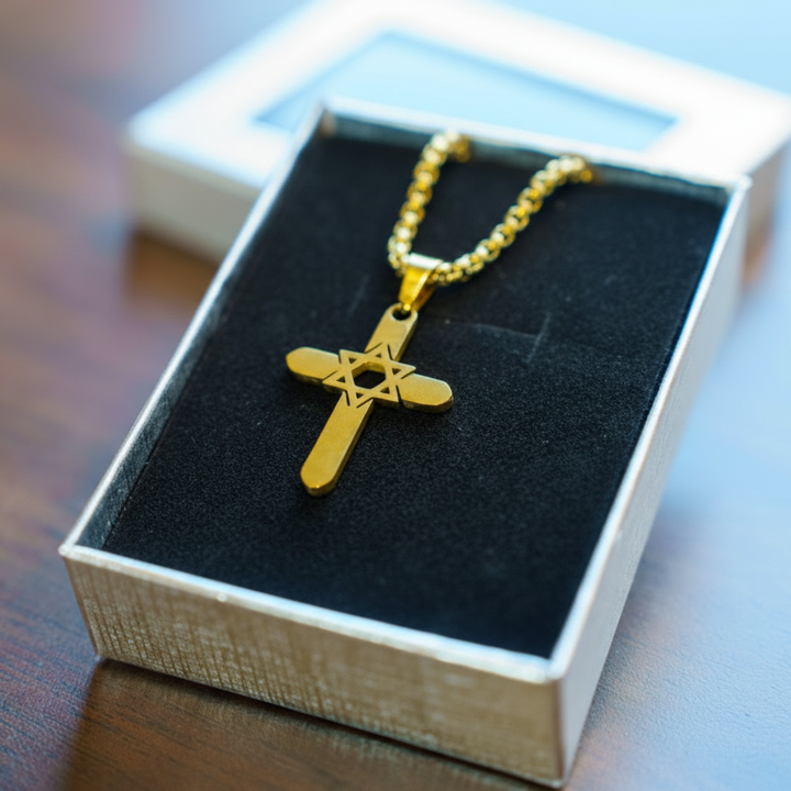 Gold necklace with a star pendant in a box on a wooden surface