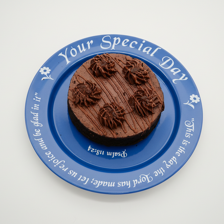 Chocolate cake with blue decorative plate on a white background